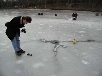 Researcher Jeffrey Wilson checked for radioactivity and magnetic field anomalies at the center of the Horton, Michigan, ice circle at Mud Lake on January 1, 2004. Photograph © 2004 by Ted Robertson.