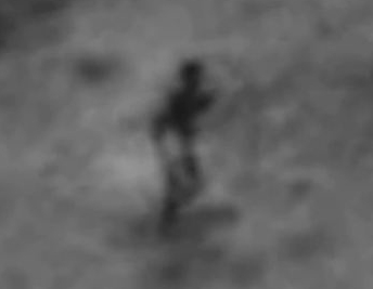 Close-up of “humanoid shadow” oriented in a “standing” position.  Is the odd Google Moon shadow produced by gullies or depressions  in moonscape? Above NASA image from “Odd figure on the Moon?” posted July 18, 2014, on YouTube by wowforreeel.