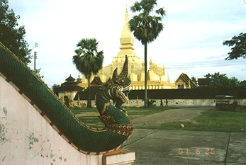 Naga carved in wood, one of two which guard the steps to the monks house near the Phrathatluang stupa. Photograph by Linda Moulton Howe.