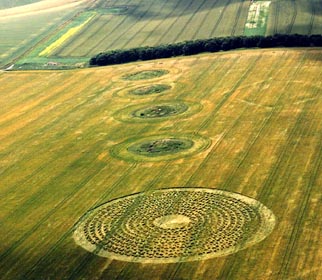 The nearly 300-foot-diameter crop formation of eleven concentric rings lined up with four ancient tumuli (burial mounds) was reported on July 6, 2003. The red line drawn on the map below along North Down tumuli ends up at Silbury Hill. Aerial photograph © 2003 by Lucy Pringle.