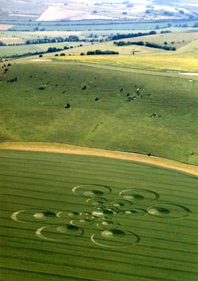 Mysterious lights were videotaped emerging from the thirty-seven circles discovered in young wheat below the Ridgeway at Ogbourne St. George, Wiltshire, England, on Sunday, June 15, in a pattern nearly 600 feet in diameter. Aerial photograph © 2003 by Lucy Pringle.