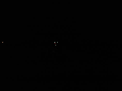Digital frame 64 (full and as taken, not enhanced), unidentified aerial craft followed by white light to the far left of frame. Time was around 10:30 p.m., on Monday night, September 19, 2005, in Fairborn, Ohio. This frame was taken before the lightning frame above. Digital image © 2005 by Michael Johnson.