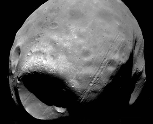 Martian moon Phobos with its Stickney Crater is considered a “captured” asteroid with low density that is in an unusual circular and low orbit around Mars. Image by NASA's Viking 1 Orbiter in 1977.