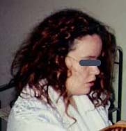 Left: "Rachel" in white robe as she was in February 1992, hair colored red. Eyes covered in Photoshop for identity protection. Right: Drawing by "Martin" of the tall, indigo blue-colored reptilian who "replaced" Rachel for several seconds. Phenomenon occurred in their shared apartment in southeastern U. S.  Photo and drawing © 2006 by Earthfiles. 