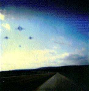  While driving on Interstate 40 on December 27, 1987, Riley Martin saw a formation of discs in broad day light. With a Polaroid camera, he snapped the remaining four frames he had left in his camera. Riley says that "magnetism is a factor in the positioning of the spacecraft." Polaroid photograph © 1987 by Riley L. Martin.