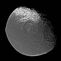 Left: Black and white Iapetus (diameter 1,426 kilometers) with a bulging "weld" around its middle. Right: Enceladus (diameter 499 kilometers) is as bright as freshly fallen snow with a bizarre, wrinkled terrain. Below: Saturn and rings imaged by Cassini spacecraft in 2004. Images credit: NASA/JPL/Space Science Institute. 