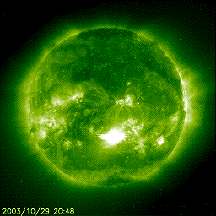 At 20:48 UT on October 29, 2003, the fifth intense solar X-Flare (near sun's center) in a week erupted on the sun, emitting light, x-rays, ultraviolet rays and plasma energies which will impact Earth yet again on October 30. Image courtesy Solar and Heliospheric Observatory (SOHO).
