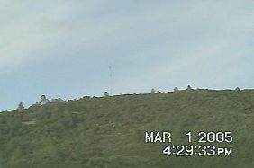 Lyons Bald Mountain, Sonora, California, photographed from Mark Olson's apartment. Camcorder image © 2005 by Mark Olson.
