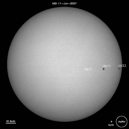 Three sunspots on the sun, January 11, 2007. Individual sunspots are often larger than planet Earth, which is shown scaled to size in the lower right, along with massive Jupiter. The scale line at lower left compares to the length of 10 Earths. Image courtesy SOHO.