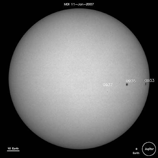 Three sunspots on the sun, January 11, 2007. Individual sunspots are often larger than planet Earth, which is shown scaled to size in the lower right, along with massive Jupiter. The scale line at lower left compares to the length of 10 Earths. Image courtesy SOHO.