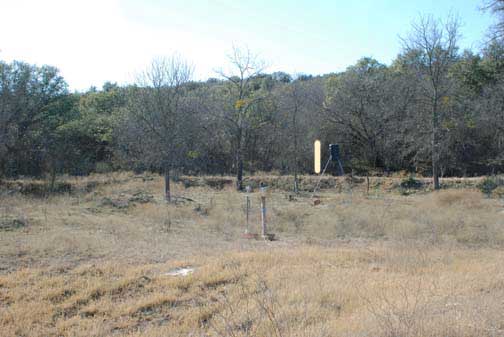 Brownwood, Texas, deer feeder site, January 30, 2008. Two Swann infrared cameras in foreground. Photoshop white line indicates approximate position of light beam in November 21, 2007, videotape that faded in, persisted for five minutes, and then faded out. Image © 2008 by Linda Moulton Howe.