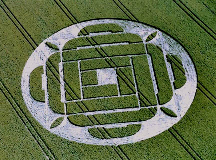 Crop formation reported June 22, 2005, in Boreham Down wheat field near Lockeridge, Wiltshire, below the West Woods. The night before on June 21, 2005, at 6:30 p.m., 200 yards from pattern's site, bicyclist Mike Booth was on the road near field when he saw three white, metallic, objects moving slowly at height of wheat heads which bent over as the machines passed. Aerial photo © 2005 by Lucy Pringle. Also see: Cropcircleconnector.com