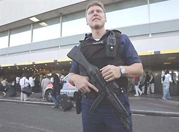 One of hundreds of police and military patrolling outside and inside Heathrow Airport, London, on August 10, 2006. Early that morning, British intelligence revealed a terrorist plot to blow up airliners en route from Britain to the United States. The threat level was raised to highest Red. Image © 2006 by Stephen Hird, Reuters.