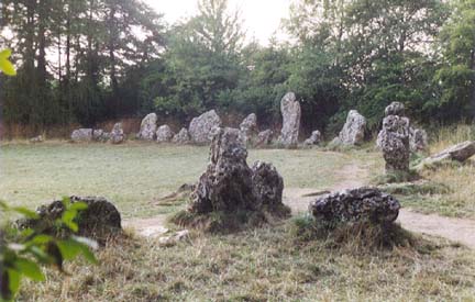 The Rollright Stones are among the more famous of the British stone circles. The site comprises a circle known as "The Kings Men,"and the remains of a megalithic tomb known evocatively as "The Whispering Knights." Image from Megalithia.