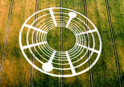 Concentric ring pattern was atop the South Field below Woodborough Hill on the Tim Carson farm famous for crop formations in Alton Barnes, Wiltshire. The German crop circle research team, Joachim Koch, M. D. and Hans-Juergen Kyborg, paid Tim Carson so they could work in his field for their private investigation. Aerial photograph © 2004 by Lucy Pringle.