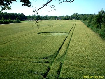 Single circle with odd ring indentation inside in the foreground; ringed circle with two odd indentations on inside circle and outside ring in background. Photograph on July 16, 2003 © 2003 by Robert Boerman.