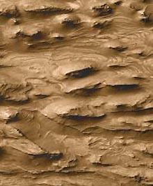 Layered, dusty Martian surface in far west Candor Chasma of the Valles Marineris, the largest canyon in the solar system. Photo courtesy NASA/JPL/MalinSpaceScienceSystems.