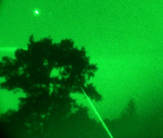 Video frame of aerial light emitting strong beam on October 10, 2009, in Murrysville, Pennsylvania. Sony HDR-VR500 HD digital camcorder attached to an ATN NVM14-3A Generation 3 Nightvision scope with a 5X zoom lens. Video image © 2009 by Alison Kruse.