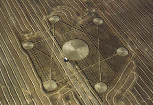 Eight years ago on September 16, 2001, farmer Ken Bickford discovered a 422-foot-diameter hexagram in his Red Deer, Alberta, wheat field. The swath on the left was his first drive through on his combine. After that, Mr. Bickford drove around the formation to preserve it. A pilot said he flew over the wheat hexagram on September 2, 2001, but did not report it. Aerial photograph © 2001 by Lyle Ford, CCCRN. Also see:  092201 Earthfiles.