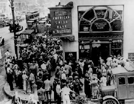   Crowd at New York's American Union Bank during a bank run early in the Great Depression that began in 1929. The bank opened in 1917, and went out of business on June 30, 1931. Image source Wikipedia.