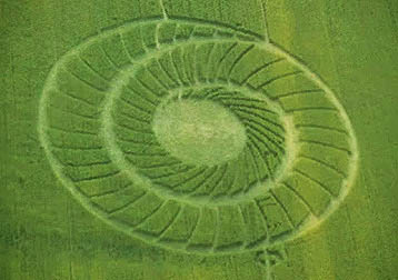 On May 20, 2012, the date of the rare annular solar eclipse, this spiral of 69 “spokes” in young wheat was reported in Bracciano, Forli Province, near Bertinoro, Italy, 50 miles southeast of Bologne. Aerial video frame © 2012 by Faenzashiatsu.