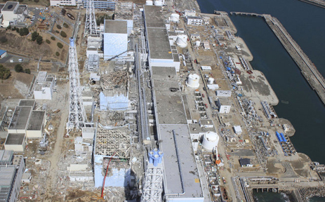 March 24, 2011, Unit 4 in foreground after explosions and fires that followed the March 11, 2011, massive 9.1 earthquake and tsunami. There are 1,231 irradiated spent fuel rods in the spent fuel pool of Unit 4, which contain roughly 37 million curies (~1.4E+18 Becquerel) of long-lived radioactivity. The Unit 4 pool is about 100 feet above ground, is structurally damaged and is exposed to the open elements. If an earthquake or other event were to cause this Unit 4 pool to drain, this could result in a catastrophic radiological fire involving nearly 10 times the amount of Cs-137 released by the Ukraine's Chernobyl Nuclear Power Plant meltdown on April 26, 1986.