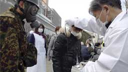 Testing citizens for radioactivity in Japan. Image © 2011 by Reuters.