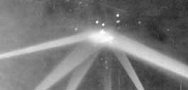 Actual photograph taken of eight search lights aimed by American anti-aircraft batteries at an unidentified diamond-shaped, glowing object or objects during the “Battle of Los Angeles” some time around 3:06 a.m. Pacific, February 25, 1942, over Santa Monica Mountains near Los Angeles, California. Photographer, Mr. Calvert.