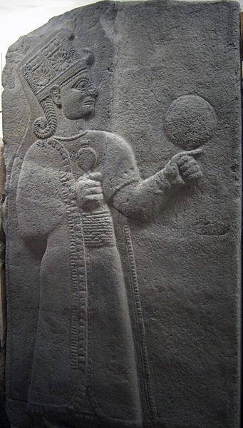Kubaba is the Hurrian Goddess of the city of Carchemish, Turkey, on the Euphrates River, at the Syrian border. She was usually depicted as a regal woman wearing a long robe, either standing or seated on a throne. She holds a mirror in her left hand and a pomegranate in her right hand, symbols respectively of magic and fertility. She was adopted by the Hittites after the fall of the Hurrians, and eventually evolved into the Phrygian Goddess Cybebe, later known as Cybele to the Romans. Source:  Museum of Anatolian Civilizations, Ankara, Turkey.
