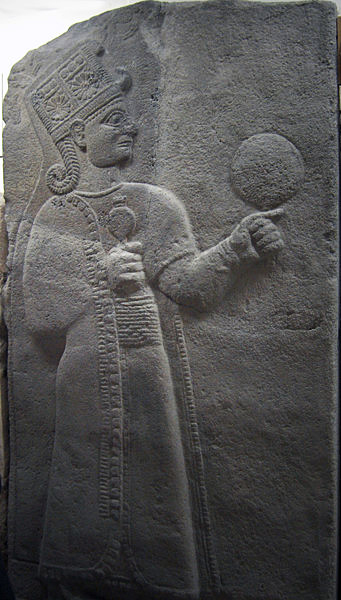Kubaba is the Hurrian Goddess of the city of Carchemish, Turkey, on the Euphrates River, at the Syrian border. She was usually depicted as a regal woman wearing a long robe, either standing or seated on a throne. She holds a mirror in her left hand and a pomegranate in her right hand, symbols respectively of magic and fertility. She was adopted by the Hittites after the fall of the Hurrians, and eventually evolved into the Phrygian Goddess Cybebe, later known as Cybele to the Romans. Source: Museum of Anatolian Civilizations, Ankara, Turkey.