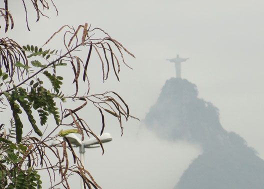Rain came and went during our stay in Rio de Janeiro, but on September 27, 2010, I was able to photograph atop the 2,400-foot-tall Corcovado Mountain, Rio’s most famous monument, Christ The Redeemer (Cristo Redentor). Constructed in 1931, Christ The Redeemer stands upright 98 feet tall and weighs 1.4 million pounds (700 tons), with outstretched, protective arms over Rio. Image © 2010 by Linda Moulton Howe.
