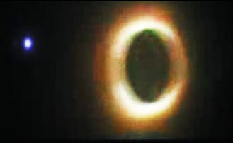 Small white object haloed in blue to left of red-white solar corona during July 22, 2009, total solar eclipse. Image © 2009 by Jijinshan Astronomical Observatory, Nanjing, Jiangsu, China.