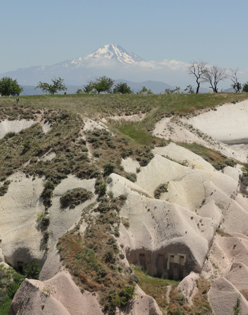 Mount Erciyes rises 12,848 feet (3,916 meters) above the Cappadocia plateau in foreground that is covered with volcanic ash mounds and “fairy houses” from this central Turkey region that had persistent volcanic eruptions millions of years ago from half a dozen volcanoes. Those continuous ancient eruptions produced the Mid-Anatolian Plateau with masses of lava and ash that are 656 feet (200 meters deep). It is possible that the Hipparion ancestor of the modern horse was killed off by all the volcanic eruptions. Image © 2012 by Linda Moulton Howe.