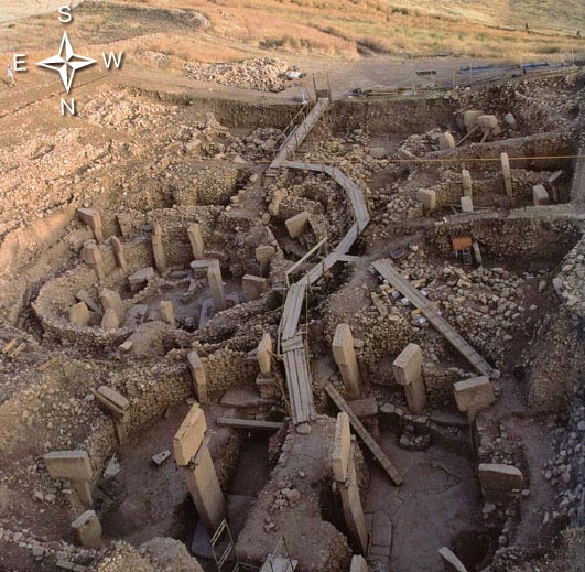 South (top), West (right), North (bottom) and East (left) view over the main excavation area at Gobekli Tepe. In the foreground Enclosure D, to the left Enclosure C, in the background Enclosures B and A. Image © 2012 by DAI, N. Becker, June 2012 issue of Actual Archaeology Magazine-Anatolia, “The First Temple of the World: Gobekli Tepe.”