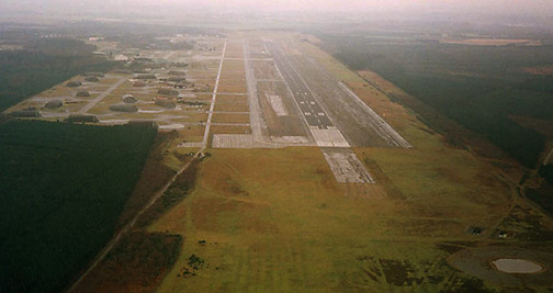 Aerial image of the runway at RAF Woodbridge surrounded by the thick Rendlesham Forest.