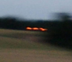 Three orange lights moving near Guy's Cliffe, Warwickshire, England, wheat formation on July 12, 2010, and caught on low-light shutter speed at around 1/15th to 1/30th of a second. Image © 2010 by Andrew Pyrka.