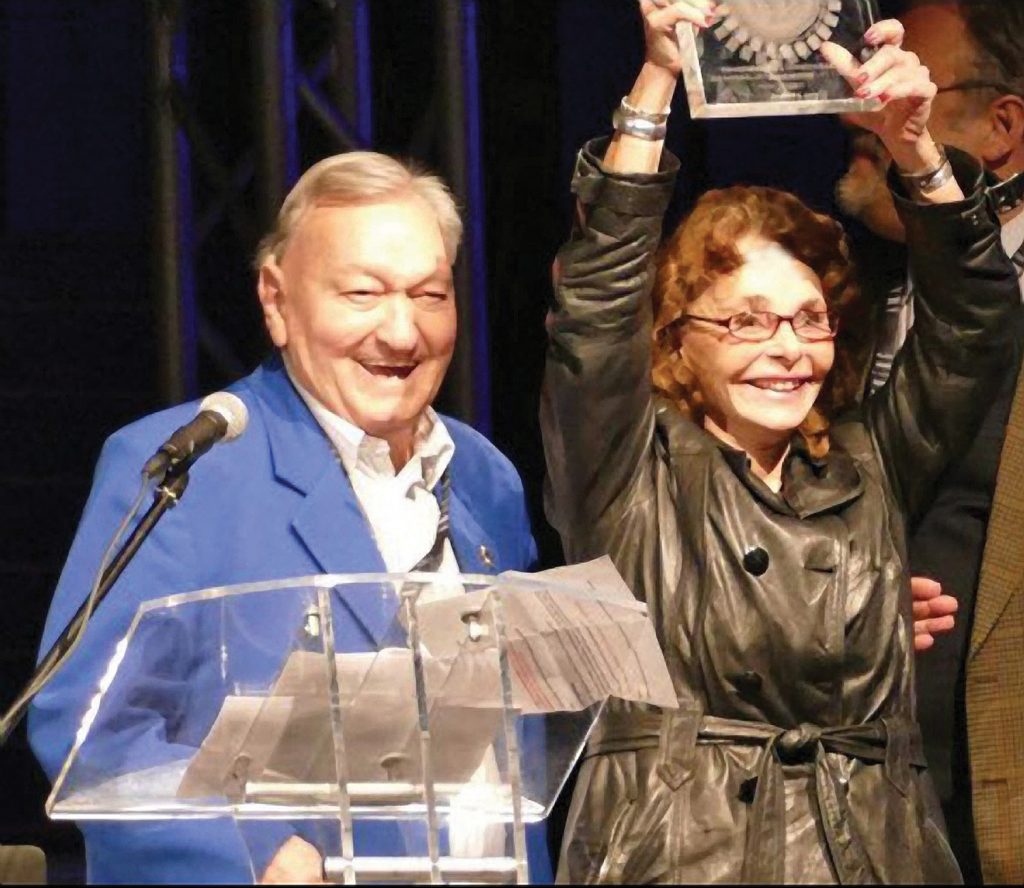 Linda Moulton Howe raised carved crystal 2017 Stellar Citizen Award presented to her by author  Erich Von Daniken on March 4, 2017, at the 2017 Awakening Conference  in the Bowlers Exhibition Centre in Manchester, England.