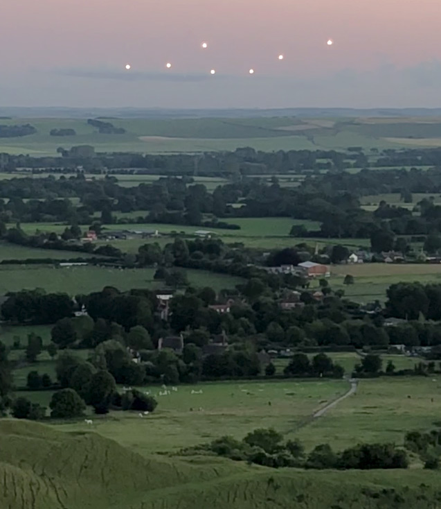 Video frame of silent, mysterious pattern-changing lights recorded for 2 minutes and 24 seconds on cell phone at 9:30 PM on June 20, 2019, by Philippe Rosset, high school French teacher while climbing Knapp Hill above Alton Barnes, England.
