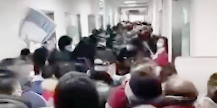 A video frame that shows people on January 24, 2020, crowding into a Wuhan, China, hospital corridor as fears of a pandemic grow in the new Wuhan coronavirus outbreak. Video frame TNYT.