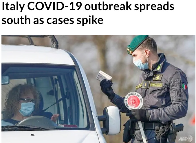 An Italian police officer checks a driver's license after Italian Prime Minister Giuseppe Conte ordered blockades in the northern regions of Italy now infected by COVID-19 and spreading south to Tuscany and Sicily on Tuesday, February 25, 2020. Image by Miguel Medina, AFP.