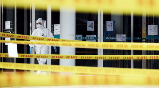 Yellow control tapes at a hospital in Daegu, South Korea, on March 1, 2020, where medical staff are wearing hazmat suits to treat patients infected with COVID-19. Image by Yonhap, AFP, Getty Images.