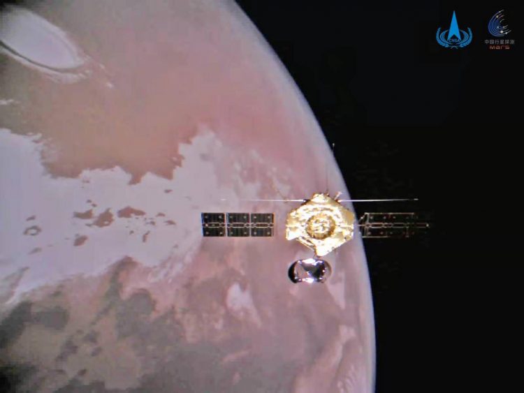 The color pictures show the orbiter flying around the Red Planet in an orbit, the ice cover on Mars’ north pole and a scene of a barren Martian plain.